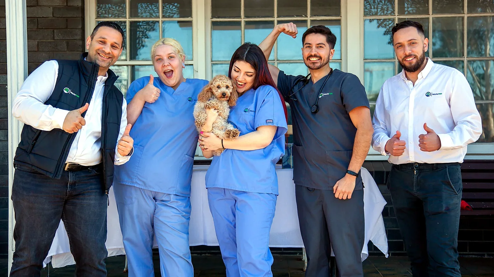 Members of the Vets for Pets team standing together with a dog
